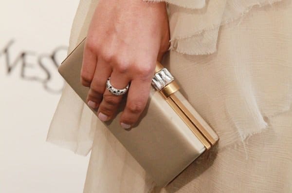 Camilla Belle carried a YSL ivory gold trimmed clutch