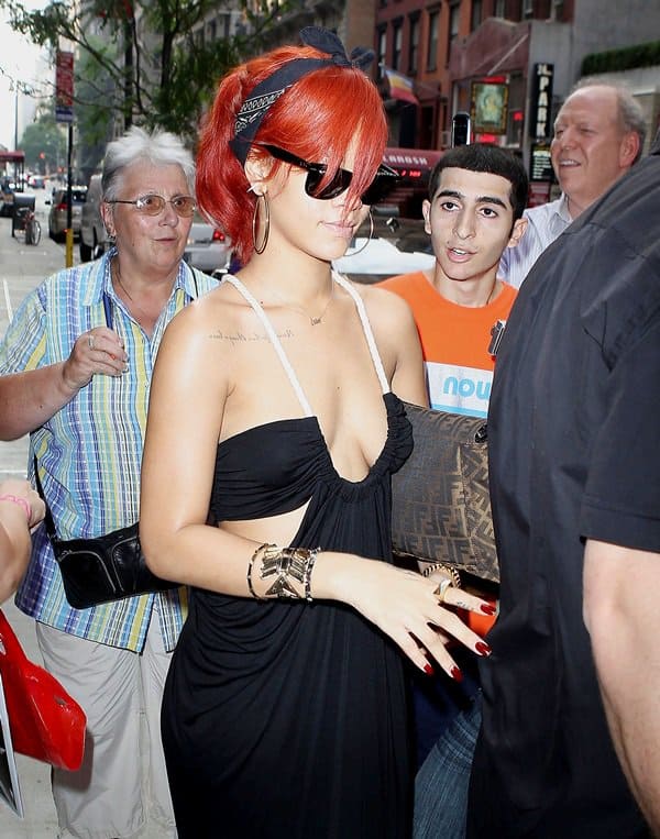 Rihanna had on a long draped cutout dress that featured rope-like straps and a seriously deep U-neckline