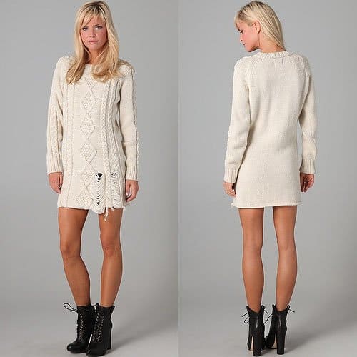 This crew-neck, cable-knit sweater dress features shredding at the bottom hem