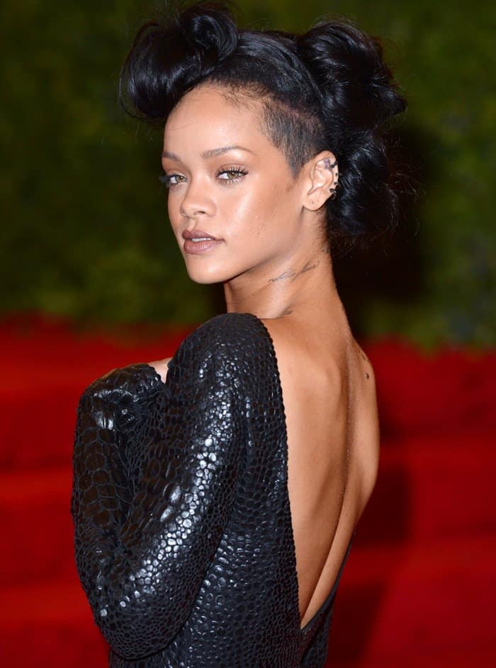 Rihanna in a backless dress with an edgy hairstyle featuring an undercut beneath three buns