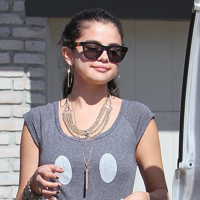 Selena Gomez wearing Westward Leaning Love Thy Neighbor sunglasses along with a Stella & Dot Rebel pendant necklace and a studded multi-chain from Forever 21