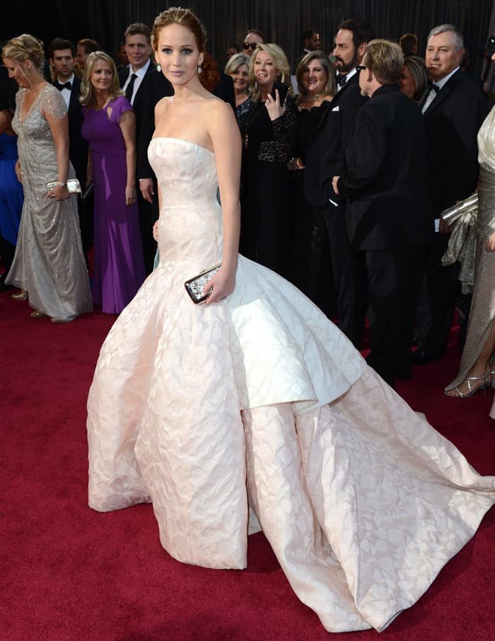 Jennifer Lawrence in a drop-waisted Dior Couture gown with a Roger Vivier clutch
