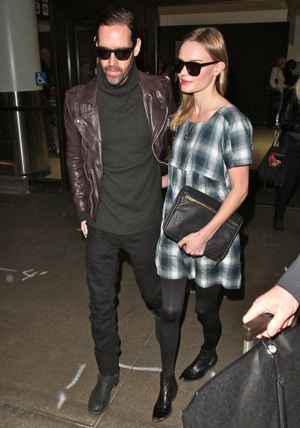 Kate Bosworth, wearing a check smock dress paired with black tights, with her boyfriend Michael Polish