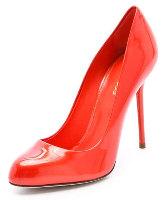 Paprika-red patent leather Sergio Rossi pumps shine with a radiant metallic luster