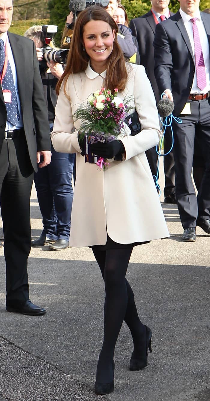 Kate Middleton wearing a Peter Pan–collared shift dress from Topshop, black tights, and black pumps