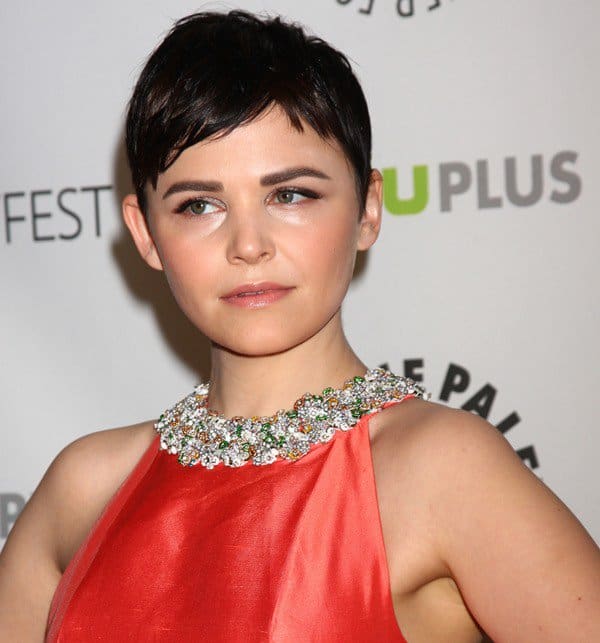 In addition to the captivating color of the dress and the alluring display of Ginnifer Goodwin's back, the standout feature unquestionably resides in its bejeweled halter neckline