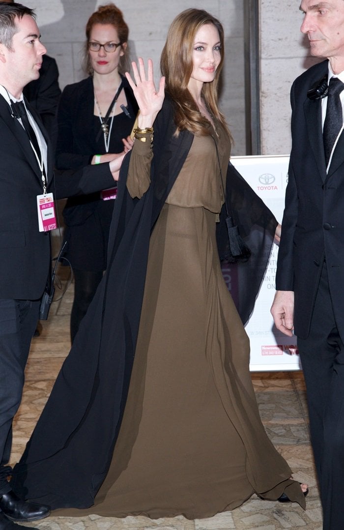 Angelina Jolie wearing a Saint Laurent maxi dress and coat at the 4th Annual Women in the World Summit at the David H. Koch Theater in New York City on April 4, 2013