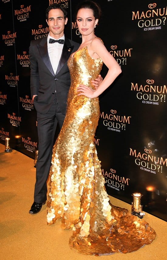Fashion designer Zac Posen and actress Caroline Correa (wearing Zac Posen's 24k gold dress) attend the screening of "As Good As Gold"