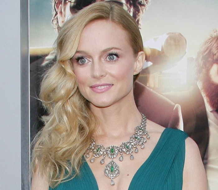 Heather Graham with her blonde curly hair swept to one side