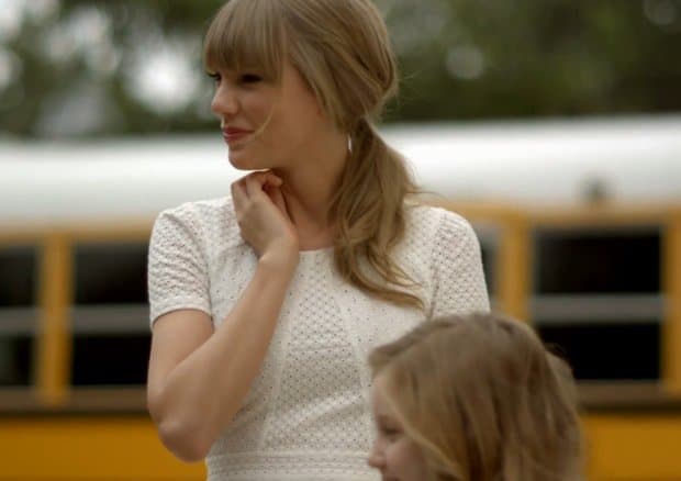Taylor Swift wearing a cute little white eyelet dress in her "Everything Has Changed" music video