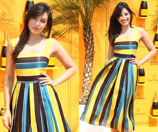 Daisy Lowe in a bright fit-and-flare dress with yellow, blue, and brown stripes