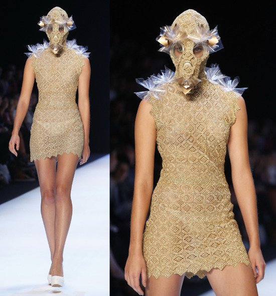 A delicate see-through lace dress combined with a gas mask covered in the same material