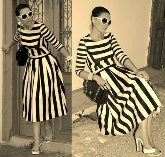 Claudine teams her striped dress with oversized sunnies and platform sandals