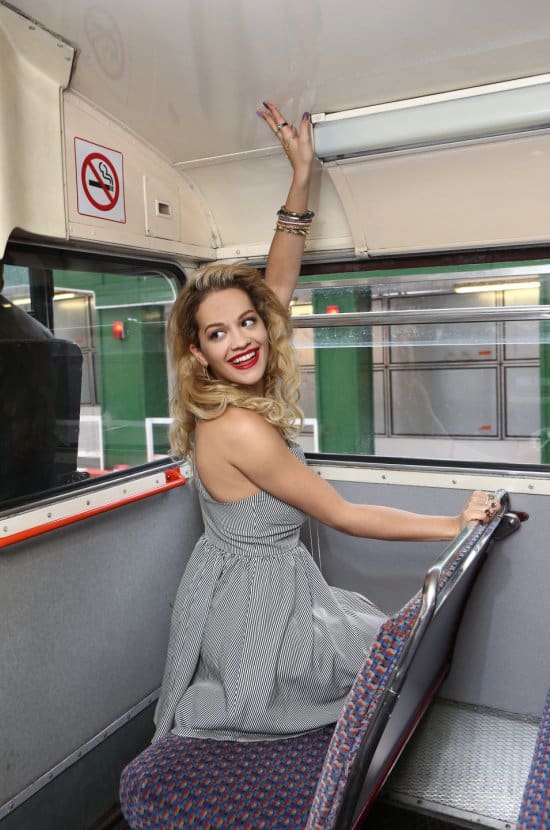Rita is photographed atop a double-decker bus in London