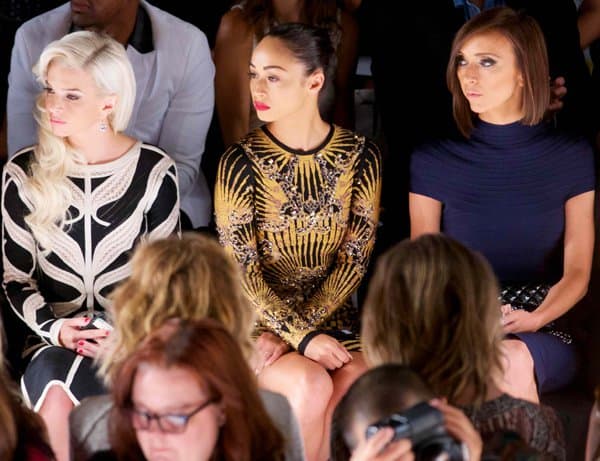Cara Santana seated among celebrities, such as Giuliana Rancic