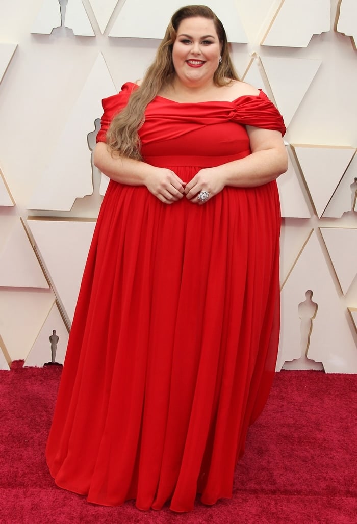 Plus size American actress Chrissy Metz wore a cherry red off-the-shoulder Christian Siriano dress at the 92nd Annual Academy Awards