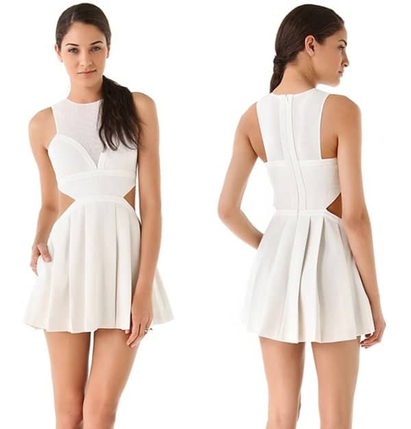 Cutout sides add allure to this white textured cotton mini dress with a mesh illusion neckline