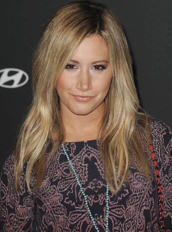 Ashley Tisdale wearing a light blue rosary necklace