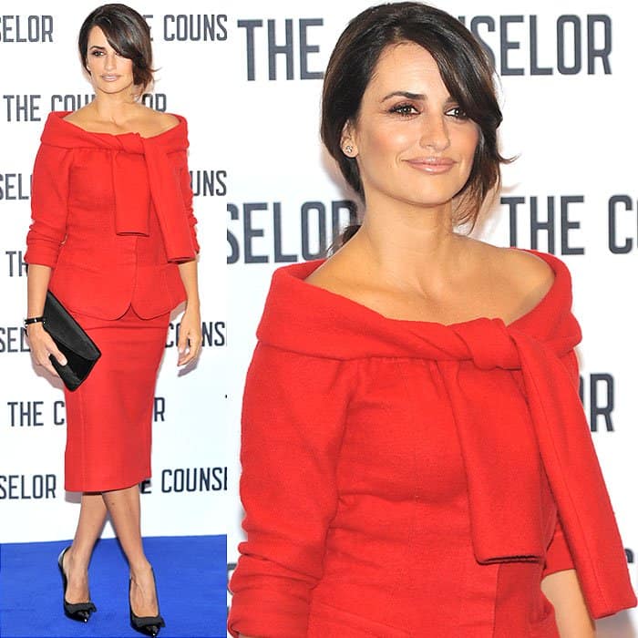 Penelope Cruz in a red tie-shoulder wool jacket and matching below-the-knee skirt at the press junket and photo call for The Counselor