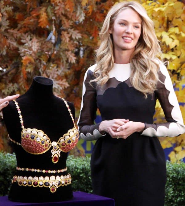 Candice Swanepoel posing with the $8 million Royal Fantasy Bra and a $2 million belt