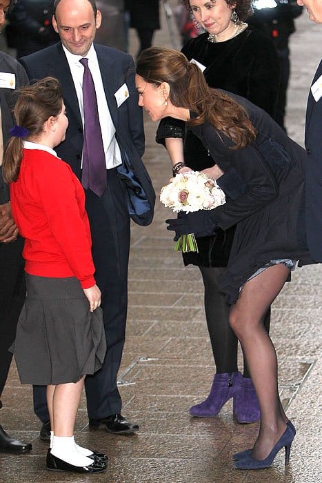 Kate managed to hold down her wind-caught skirt while still focusing on her chat with the school girl