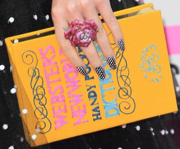 Singer Katy Perry totes an Olympia Le-Tan ‘Webster’s New World Dictionary’ box clutch 