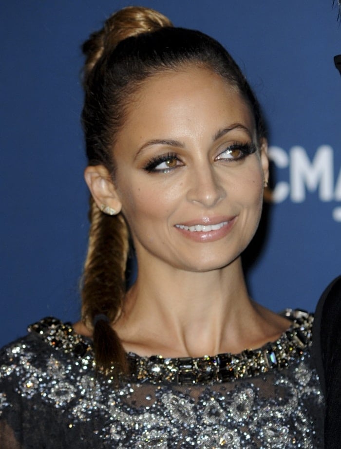 Nicole Richie shows off her underwear in a sheer dress by Dolce & Gabbana featuring silver beading and feather-and-bedazzled cuffs