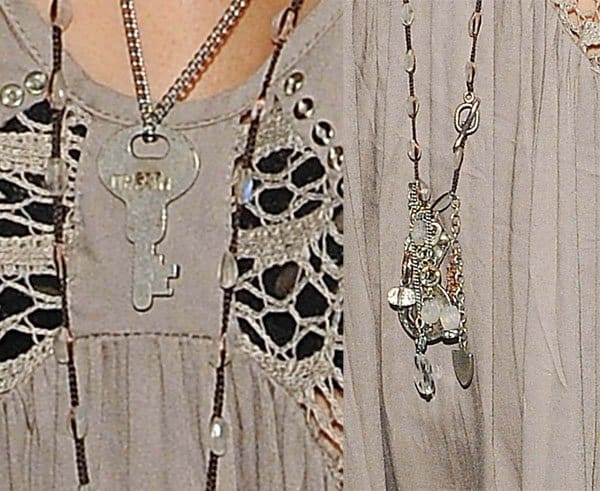 Ashley Tisdale accessorized with silver necklaces and rings