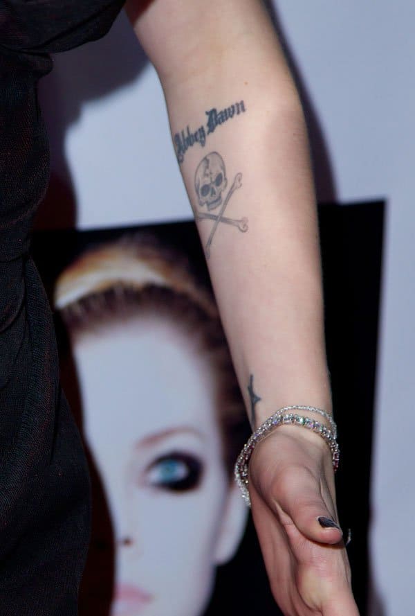 Avril Lavigne showing off the skull and crossbones tattoo below her “Abbey Dawn” ink