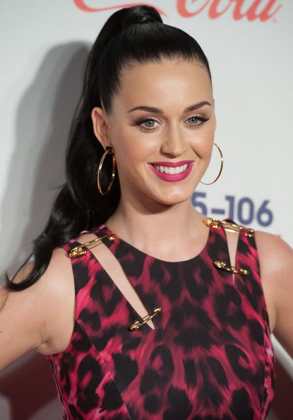 Katy Perry added to the dramatic effect of her look by sporting a high ponytail, pairing it with bold fuchsia lips and large gold-hooped earrings