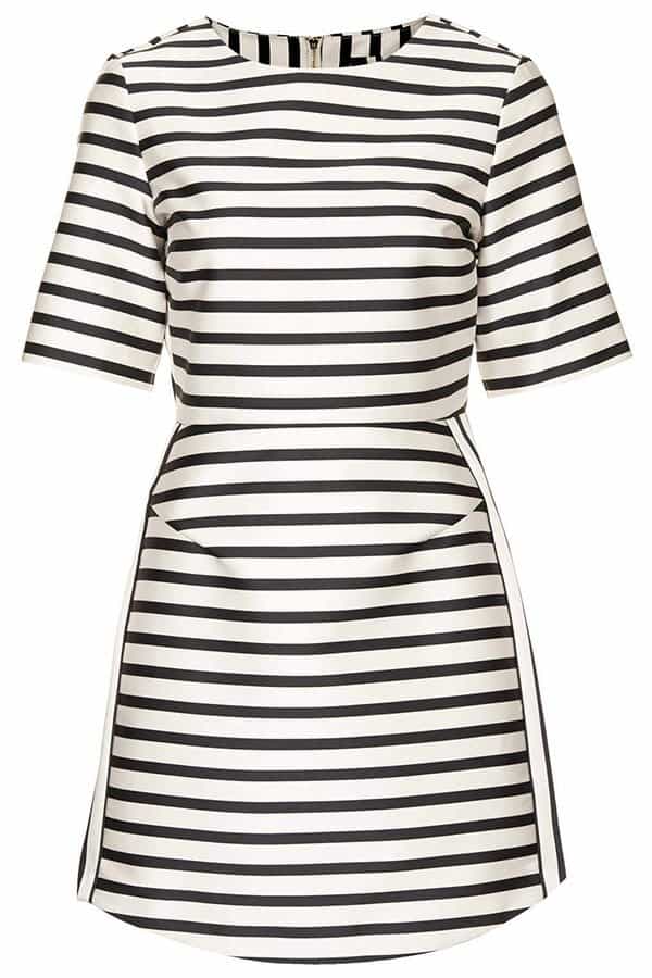 A satin-crafted dress patterned in black-and-white stripes comes alive with jazzy shimmer