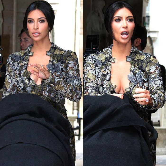 Kim Kardashian and daughter North in a baby buggy, leaving their residence in Paris