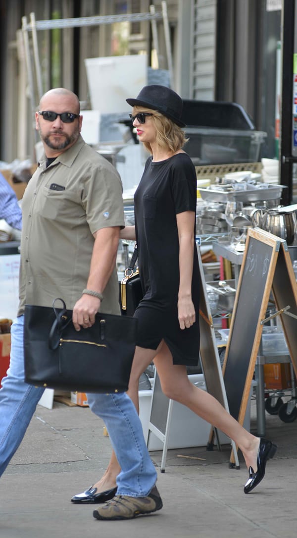 Taylor Swift's casual wide-neck jersey dress features a patch bust pocket and an asymmetrical hem