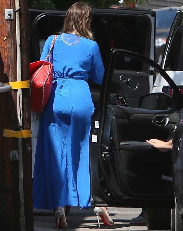 Khloe Kardashian styled her blue maxi dress with a Chanel chain around flap shoulder handbag