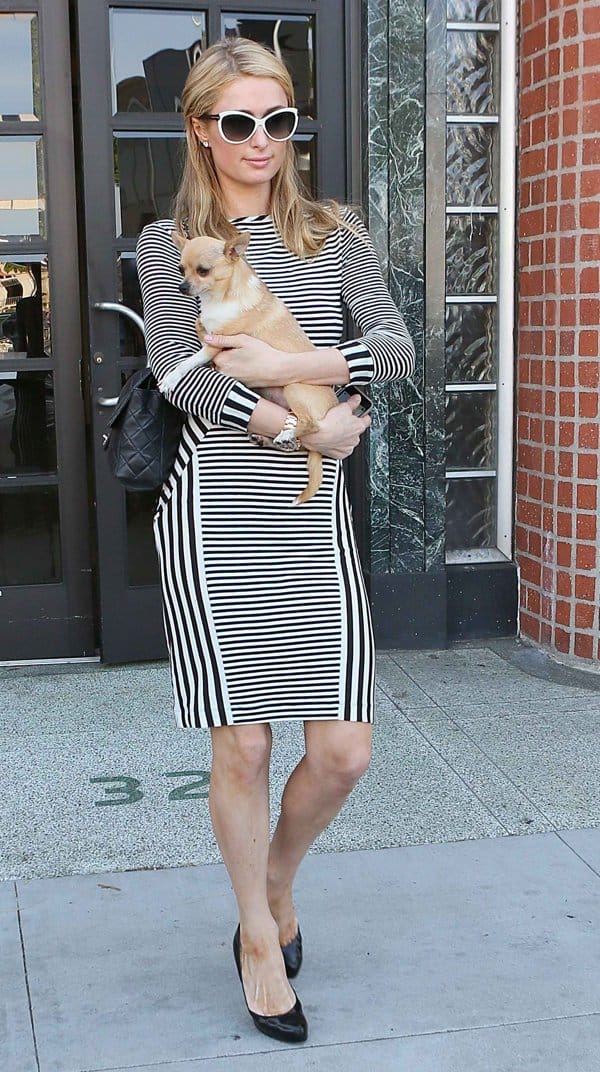 Paris Hilton flaunts her legs in a striped body-con dress