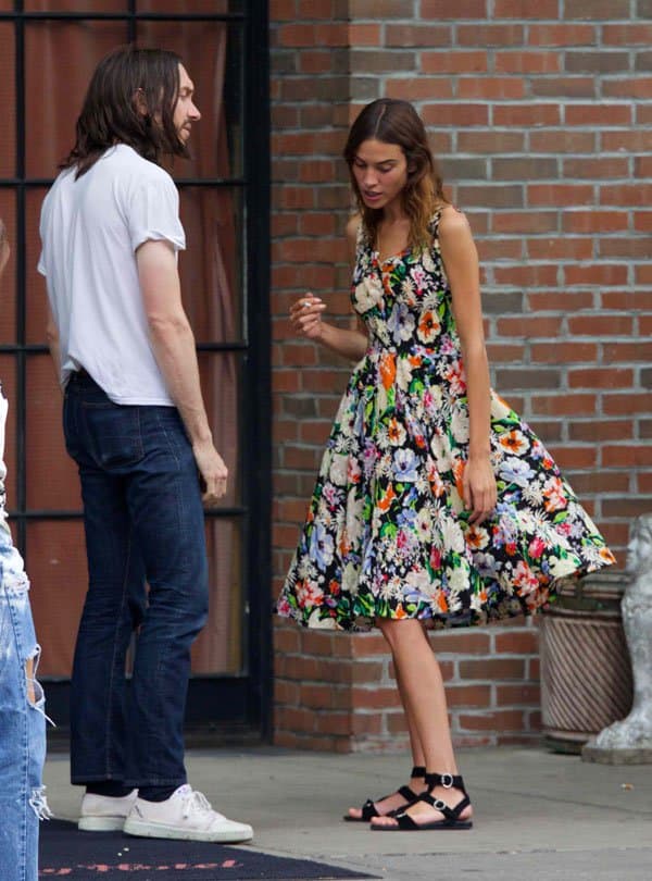Alexa Chung smoked a cigarette while chatting with a male friend