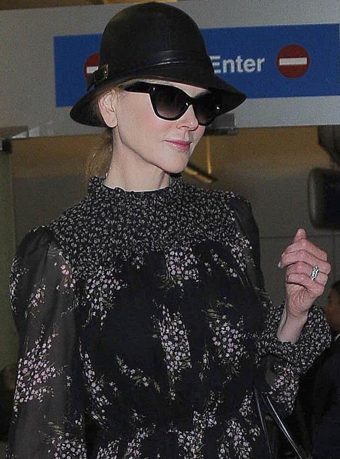 Nicole Kidman at Los Angeles International Airport wearing a black leather hat, sunglasses and floral peasant dress on October 3, 2014