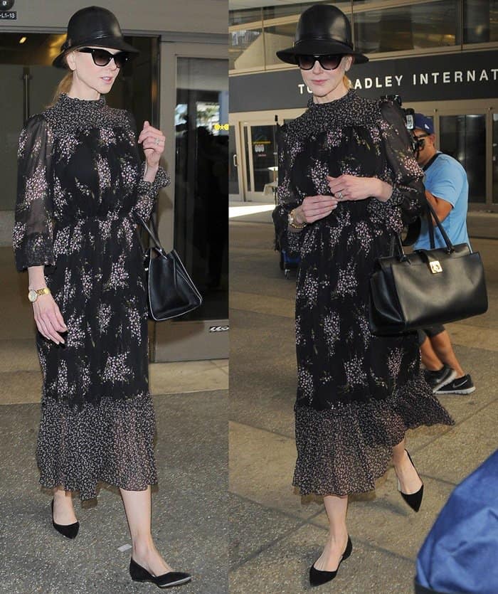 Nicole Kidman donned a floral dress from the Michael Kors Resort 2015 collection that she styled with a Salvatore Ferragamo bag, a black leather fedora, black sunglasses, and a pair of black flats