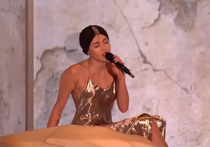 Miley Cyrus performed "Wrecking Ball" on a mountain-shaped stage prop and received a standing ovation from the judges for her emotional performance