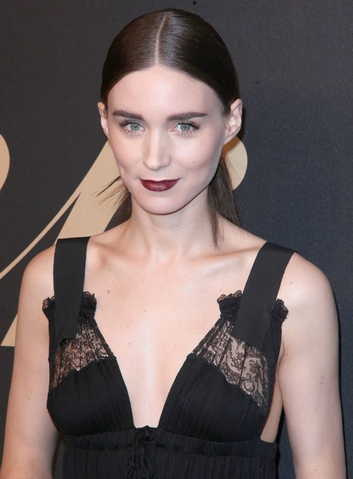 Rooney Mara's hair was slicked back, and she finished the look with a deep berry lip, creating a chic and elegant gothic romantic style