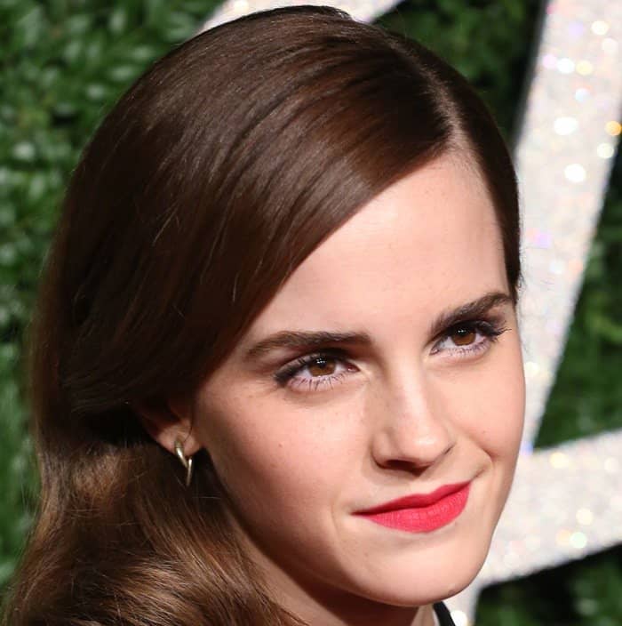 A bold red lip and sleek side-swept waves completed Emma Watson's effortlessly elegant look