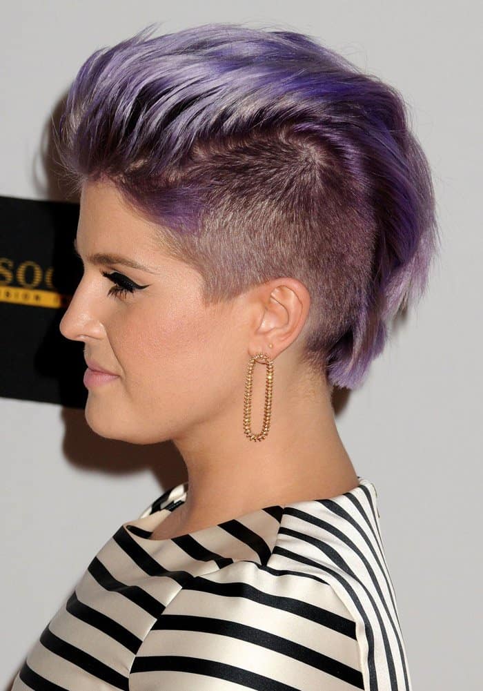 Kelly Osbourne shows off her shaved head, with only a purple mohawk remaining