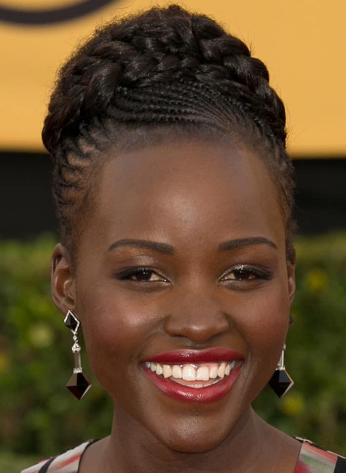 Lupita Nyong’o shows off her sexy lips and Art-Deco-inspired Fred Leighton earrings