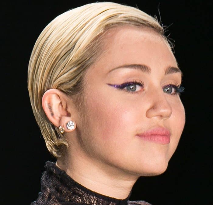 Miley Cyrus has the word “LOVE” on the inside of her right ear