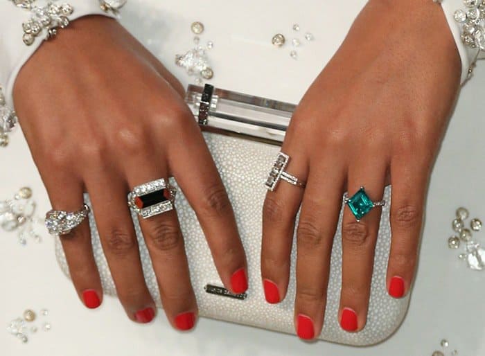Singer Solange Knowles styled her beautiful white Naeem Khan gown with a clutch, red manicure, and a variety of rings