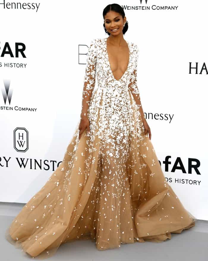 The cinched-in waistline flattered Chanel Iman's form and the skirt cascaded in a dramatic style, with delicate white flowers in a unique tan shade that added a touch of elegance to the entire ensemble