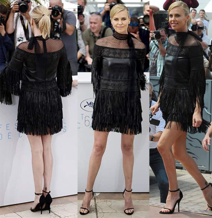 Charlize Theron attended the 'Mad Max: Fury Road' photocall at the 2015 Cannes Film Festival in a Valentino Fall 2015 black dress featuring fringe detailing and point d’esprit yoke