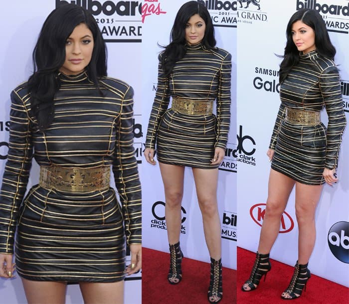 Kylie Jenner in a Balmain gold lurex striped leather dress