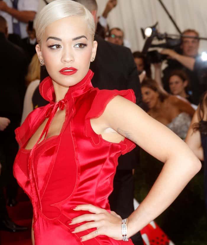 Rita Ora stuns in a recycled Yves Saint Laurent Chinese collection dress by Tom Ford, recut from his archives, at the 2015 Met Gala with her stylist Jason Rembert, where the theme was China: Through the Looking Glass