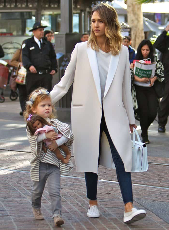 Jessica Alba, in a Gerard Darel Catia coat and Rachel Zoe sneakers, with her daughter shopping